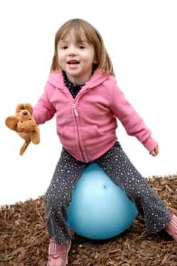 Photo: Child bouncing on large ball