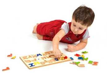 Photo: Child playing with a puzzle
