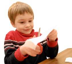 Photo: Boy cutting paper