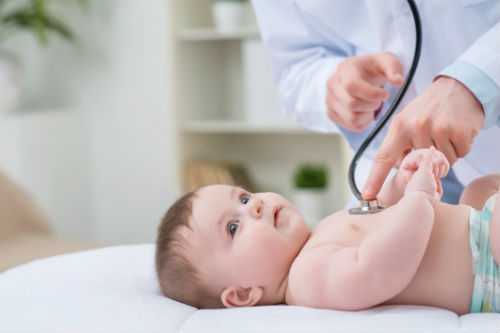 Photo of baby being examined by a doctor