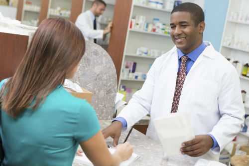 Photo of pharmacist discussing a prescription with patient