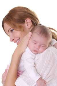 Mom holding infant on her shoulder.