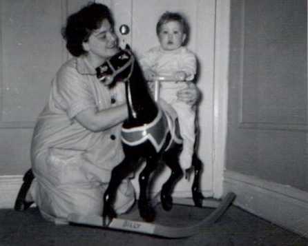 William with his mom as a child on a hobby horse