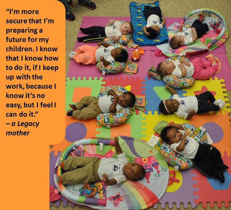 Photo of multiple babies laying down on a playroom floor. 