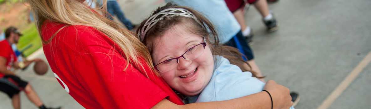 Photo of special olympics participant hugging a woman