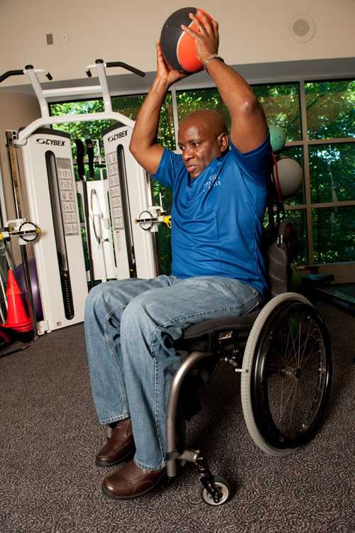 A man in a wheelchair holding a ball