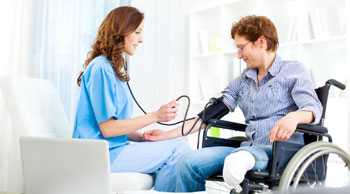 Nurse checking Adult with disabilities blood pressure