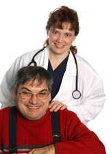 Doctor standing behind a man with her hands on his shoulders