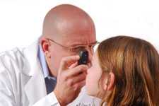 doctor looking at girls eyes