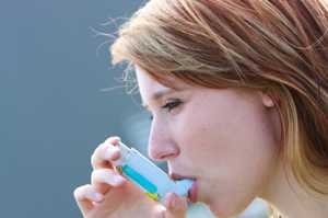 Woman taking asthma medication