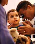 Doctor examining a boy's ear