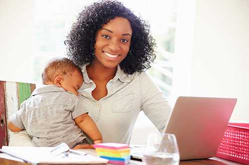 A mother working from home with her baby