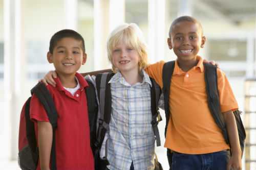 Photo of three diverse race boys standing together