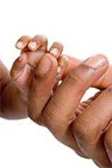 Infant holding parent's finger