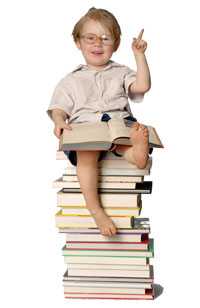 Boy sitting on the top of stacked books