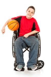 Photo: Boy in a Wheelchair holding a basketball