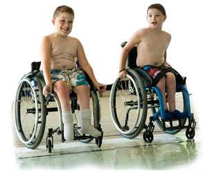 Two boys in wheelchairs getting ready to go in the pool.