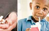 Broken cigarettes in a person's hands and an African-American boy drinking a milk box