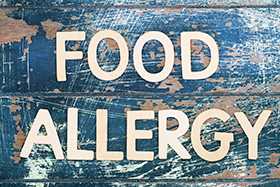 Photo of an old sign that says Food Allergy.