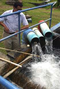 Image of a man assessing a water treatment system in St. Lucia