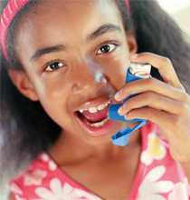 Young girl using an asthma inhaler.