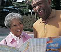 Senior couple looking at map while sightseeing.