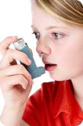Girl using an asthma inhaler