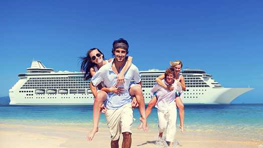  Couples on beach with cruise ship behind them