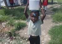 Photo: Haitian girl with water bucket on head