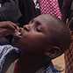boy in cameroon taking cholera vaccine