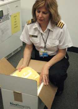 Lisa Poray wraps a shipment of life saving drugs.