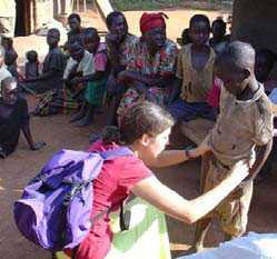 A woman examining a child in Uganda.
