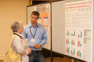 A student researcher presents his poster at the 2012 National Conference on Health Statistics Poster Session.