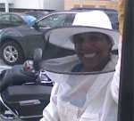 Photo of Claressa Lucas in a bee keepers suit