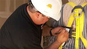 man checking a harness