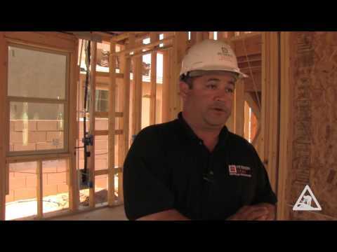 Construction worker inside a wood building frame