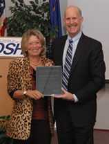 NIOSH Director Dr. John Howard presents Dr. Linda Rosenstock with the James P. Keogh Award.