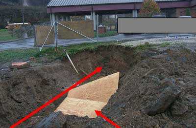 Location of victim in trench when sides collapsed. Plywood used by emergency response personnel.