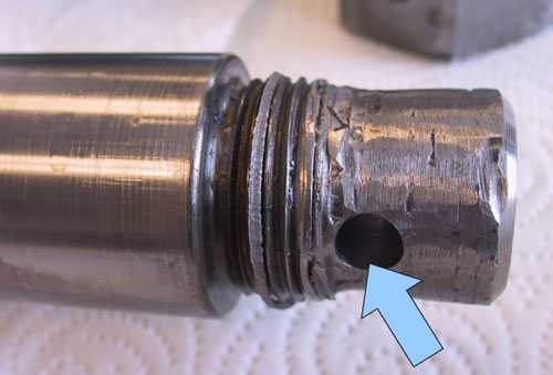 Photo 4. The thread of the failed cylinder rod was ground off and a hole had been drilled through the rod.