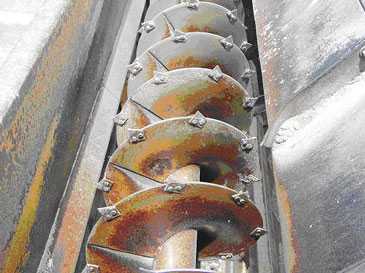Auger portion of the feed mixer-grinder. Note the razor-blades mounted on the auger to facilitate cutting/grinding.