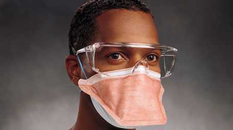 Healthcare worker with filtering facepiece respirator and protective eyewear.