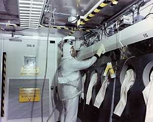 worker wearing full body protective clothing