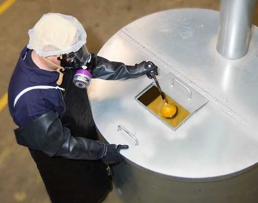 worker retrieving diacetyl from a large cistern 