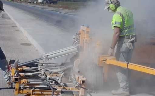 worker performing highway construction