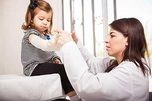 nurse helping little girl