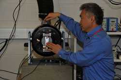 Project officer Ren Dong sets up the vibration system. (Photo by NIOSH)