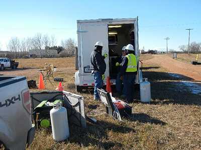 researchers working outside the portable field laboratory