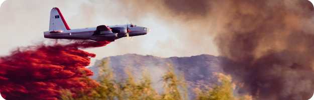 	Airtanker aircraft drops retardant on wildfire in California. 