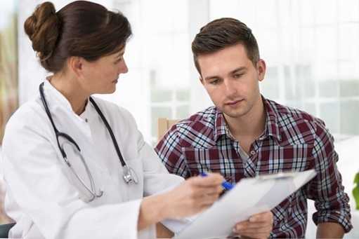 Doctor discussing periodic medical exam with a male patient 