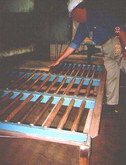 	Worker using roller sections at the back of the shear